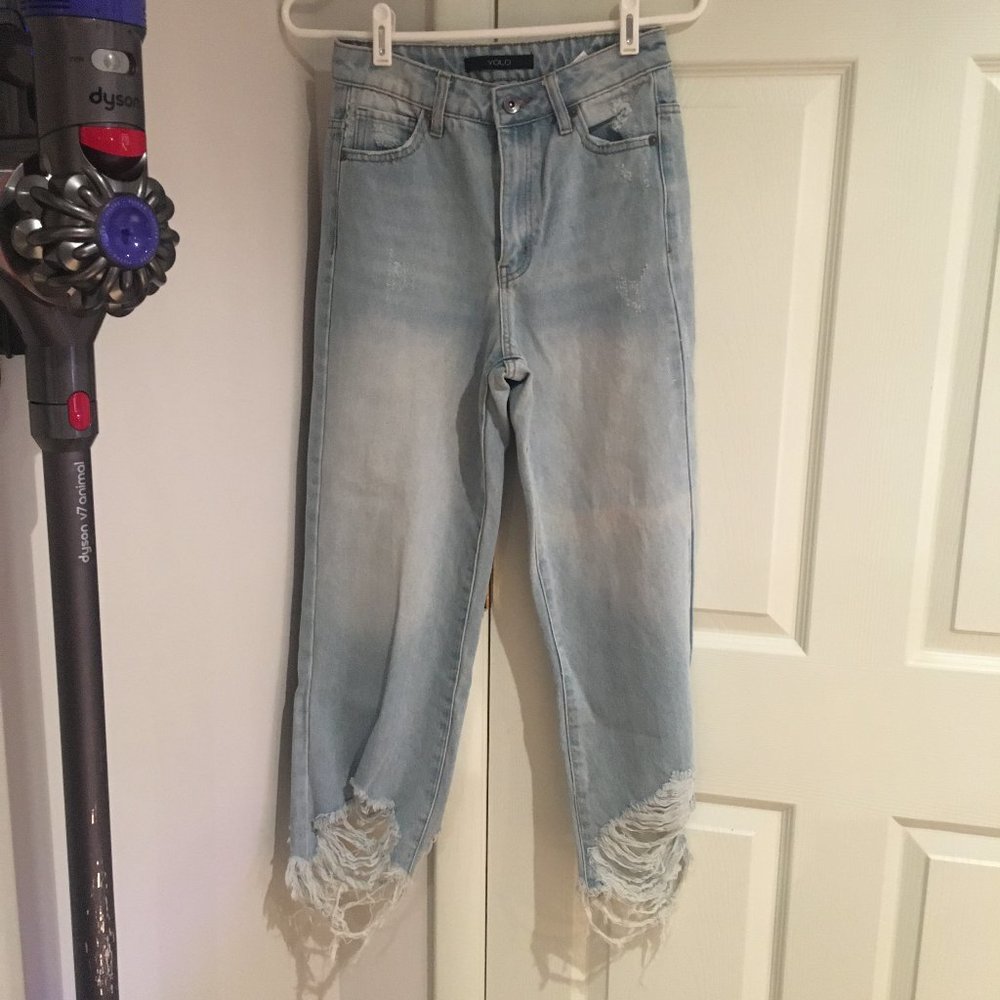 light blue denim jeans ripped at the bottom